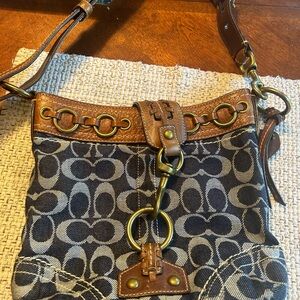 Used genuine Coach pocketbook and wristlet . Denim and leather , good shape